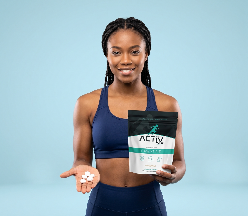 Woman holding a package of Activtab Creatine with supplements on a light blue background